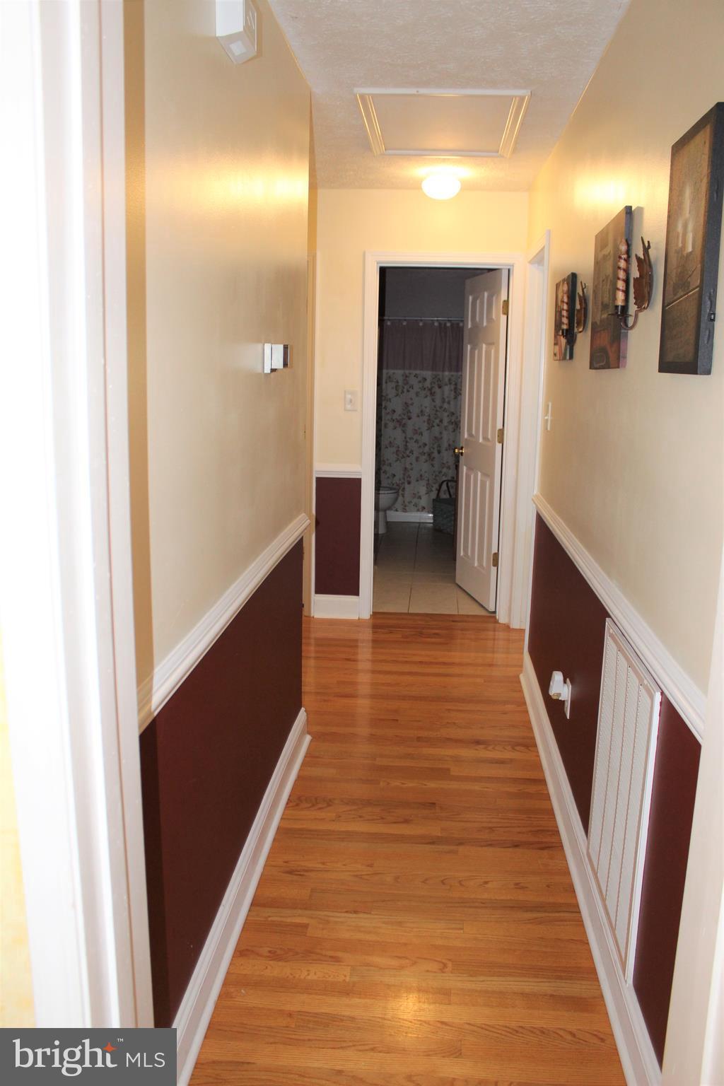 3307 Cabin Road Reva, VA 22735 - Photo 11 of 30 a hallway with wooden floor and staircase