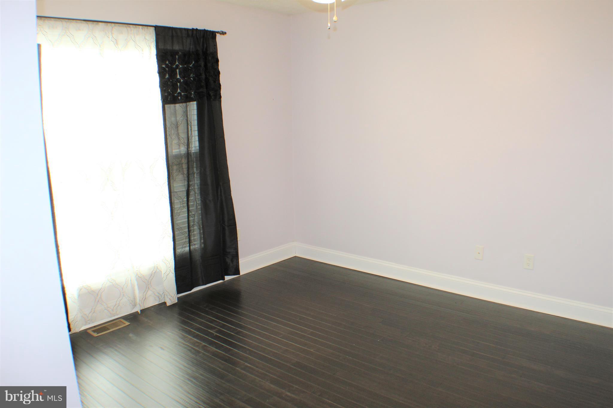 3307 Cabin Road Reva, VA 22735 - Photo 18 of 30 an empty room with wooden floor and entrance