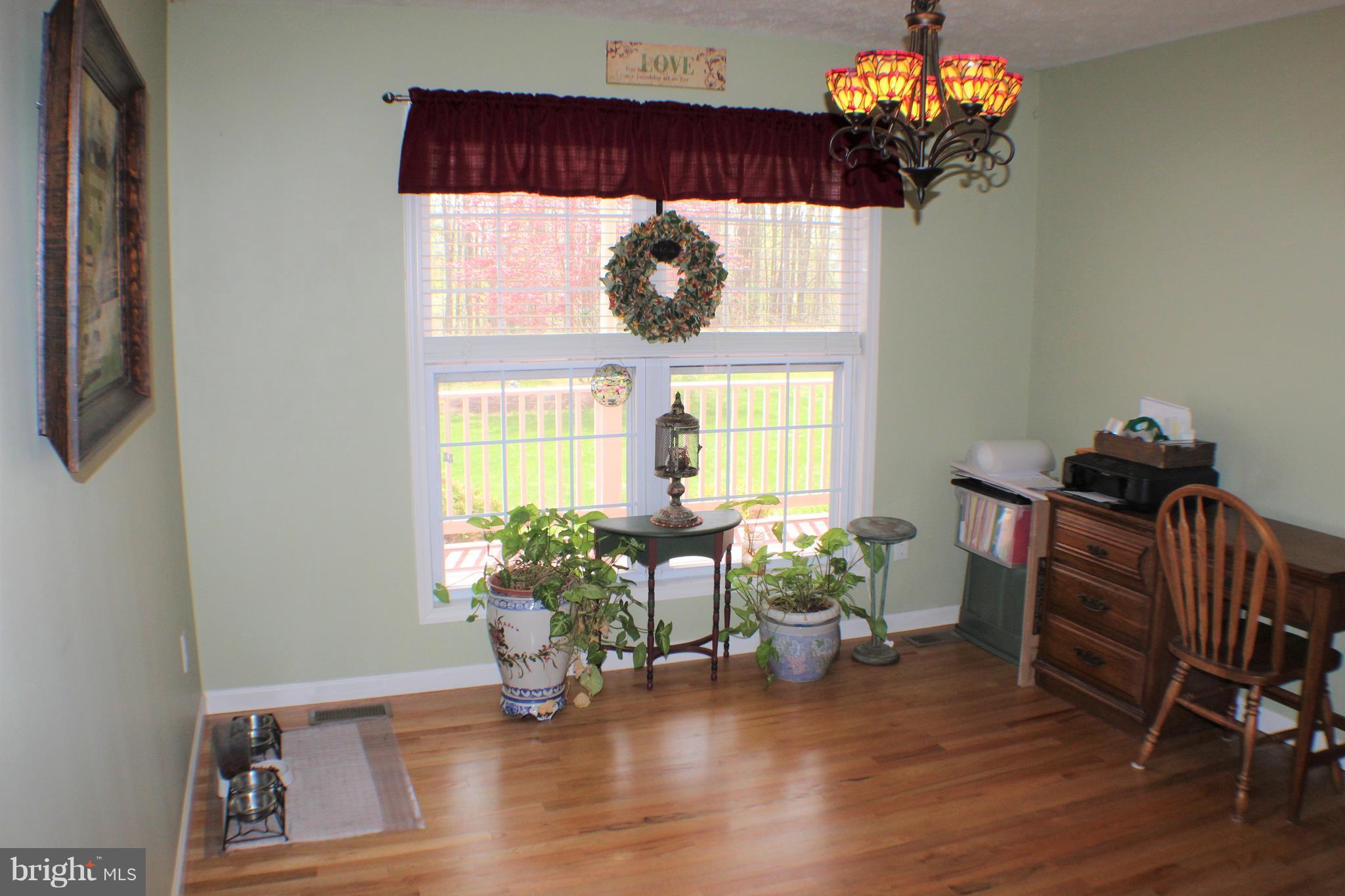 3307 Cabin Road Reva, VA 22735 - Photo 7 of 30 a living room filled with furniture and a chandelier
