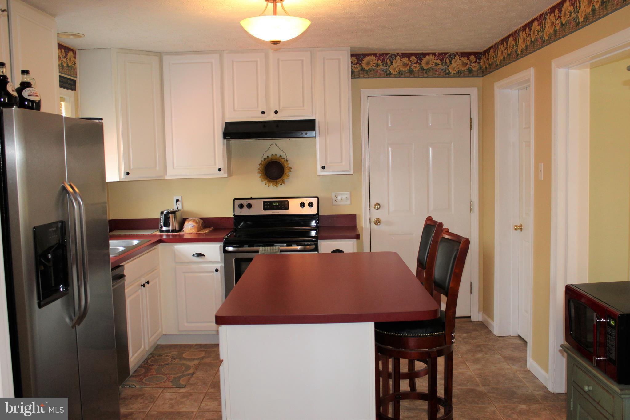 3307 Cabin Road Reva, VA 22735 - Photo 9 of 30 a kitchen with a refrigerator a stove a sink and a dining table