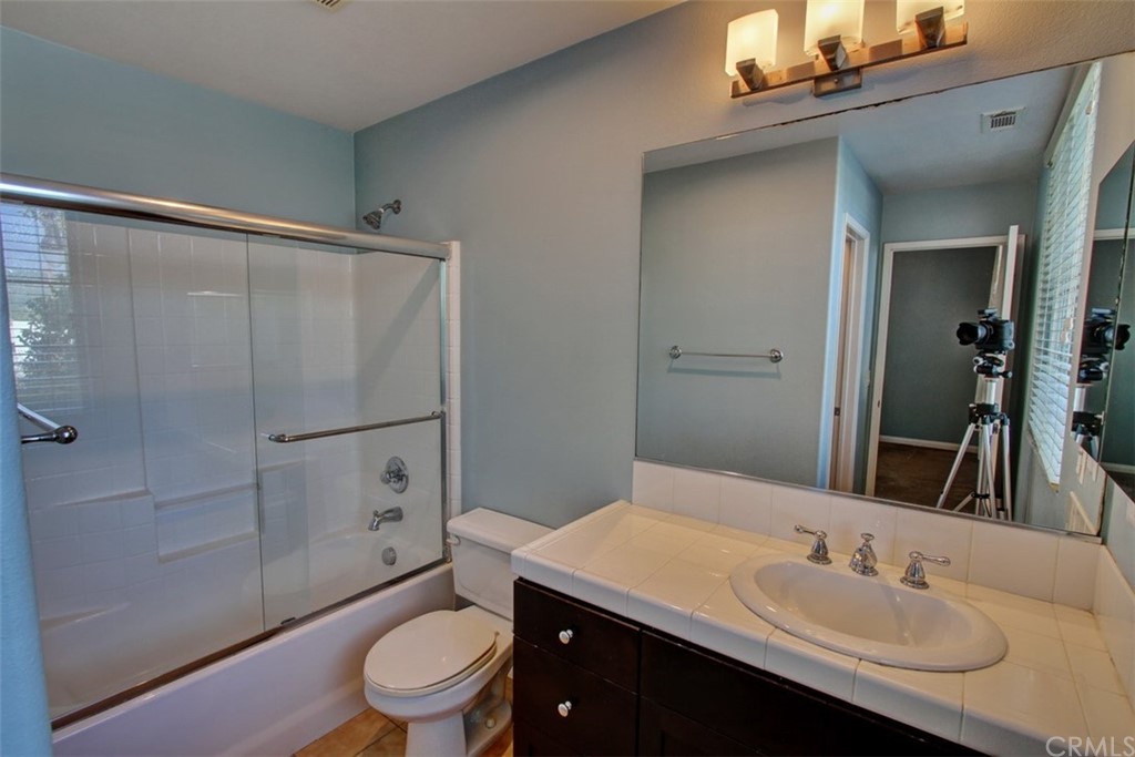 16073 Gables Loop Whittier, CA 90603 - Photo 17 of 31 a bathroom with a sink a toilet and shower