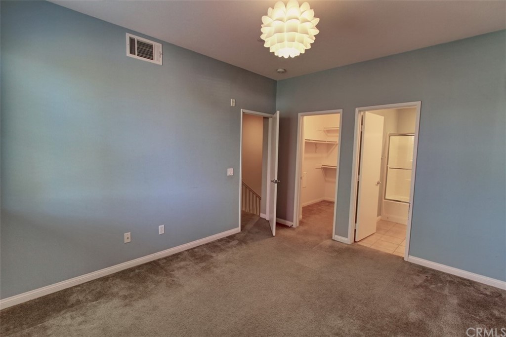 16073 Gables Loop Whittier, CA 90603 - Photo 20 of 31 an empty room with a chandelier