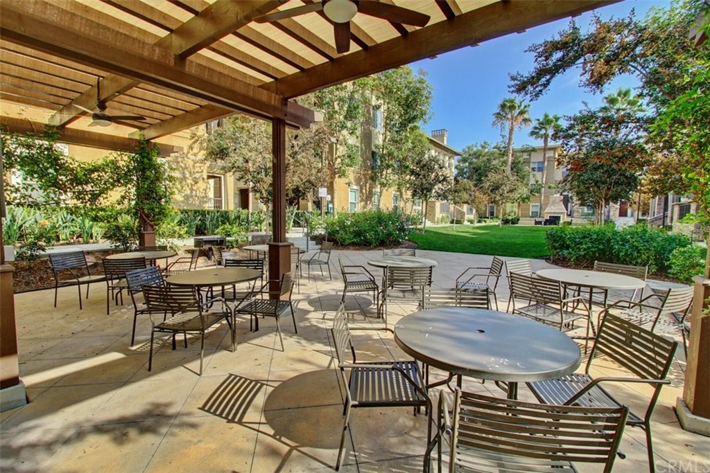 16073 Gables Loop Whittier, CA 90603 - Photo 25 of 31 a view of a patio with a dining table and chairs with wooden floor