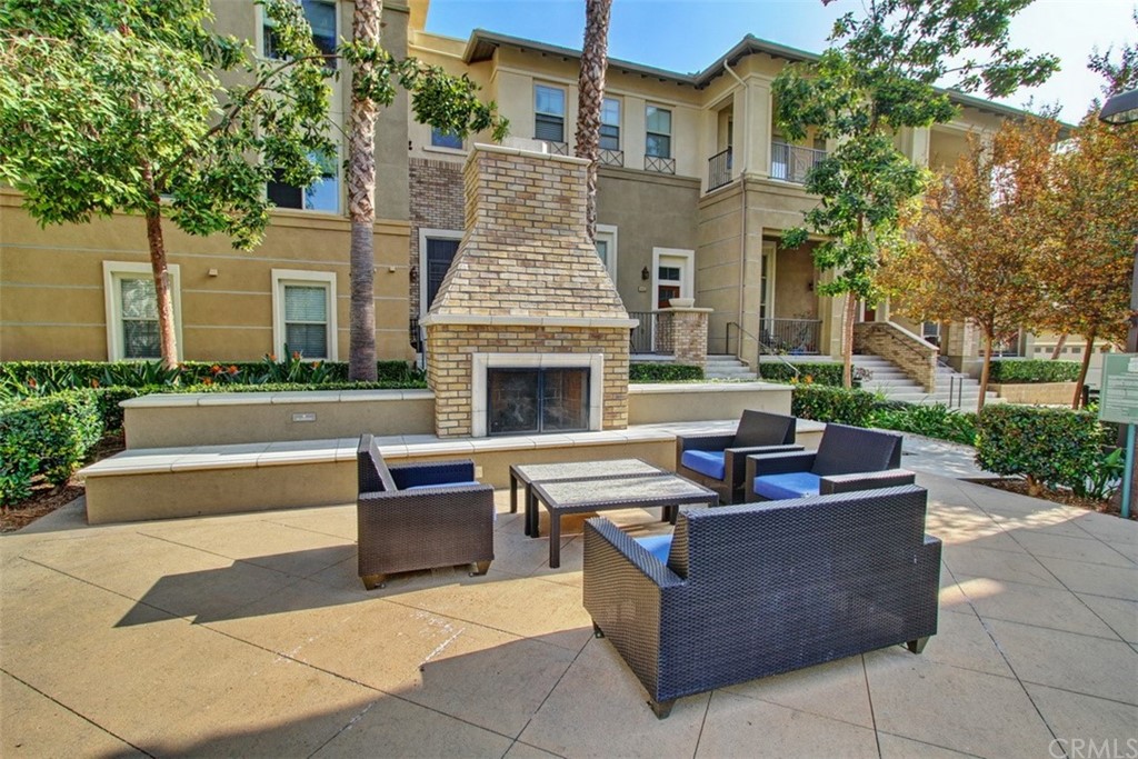 16073 Gables Loop Whittier, CA 90603 - Photo 31 of 31 a view of a patio with couches table and chairs with plants and trees