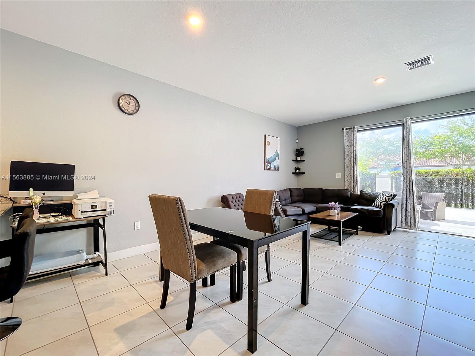 10888 Southwest 235th Lane Homestead, FL 33032 - Photo 14 of 36 a view of a dining room with furniture