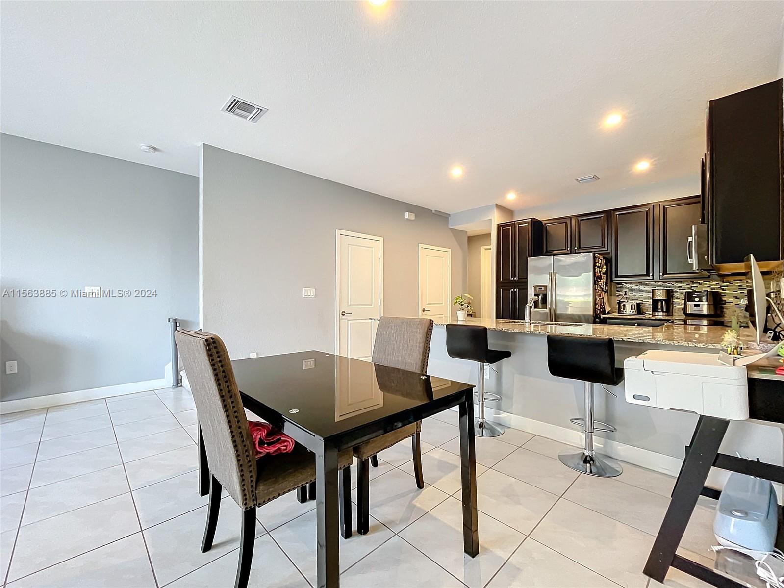 10888 Southwest 235th Lane Homestead, FL 33032 - Photo 15 of 36 a view of a dining room with furniture