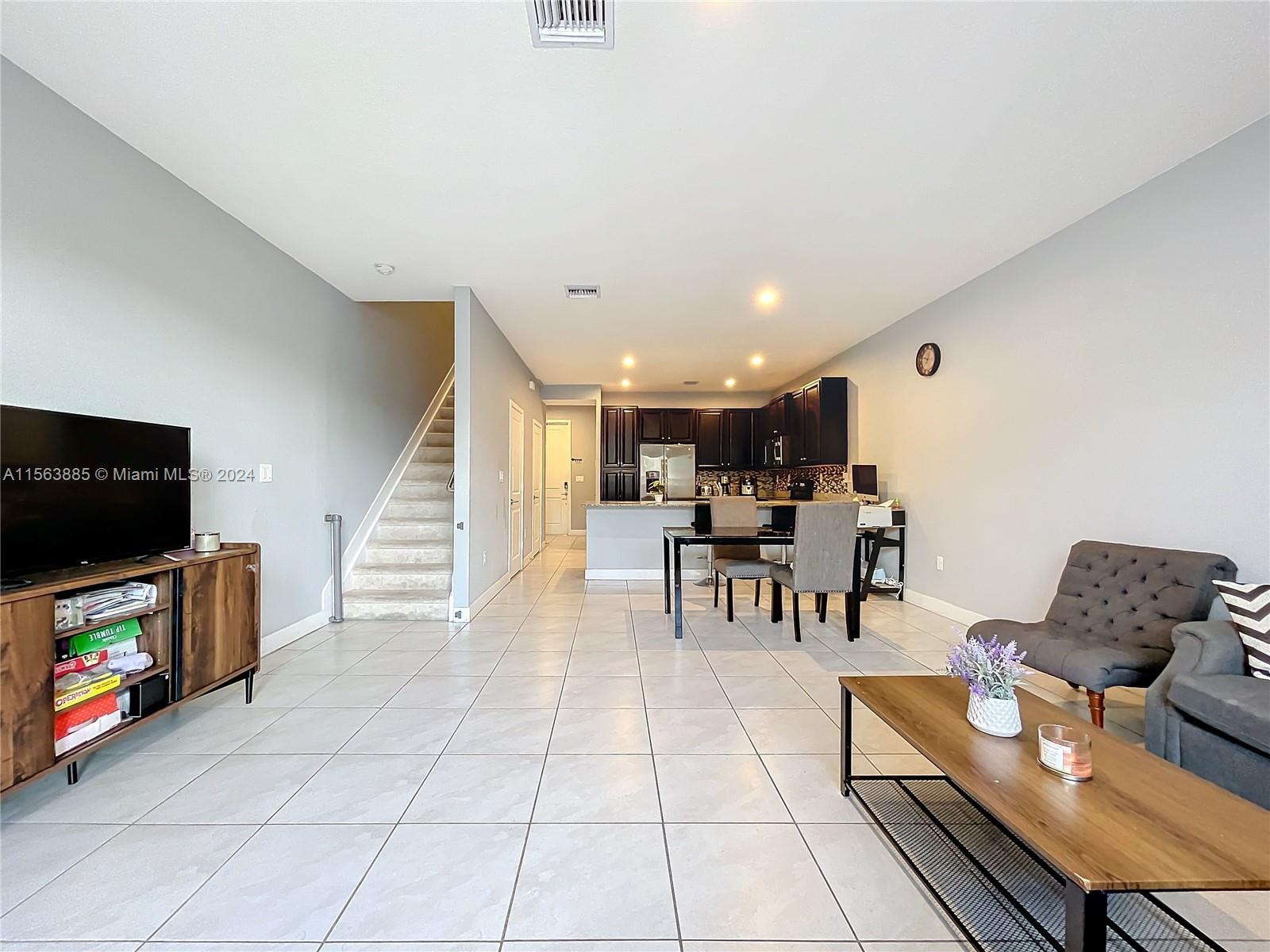 10888 Southwest 235th Lane Homestead, FL 33032 - Photo 16 of 36 a living room with furniture and a flat screen tv