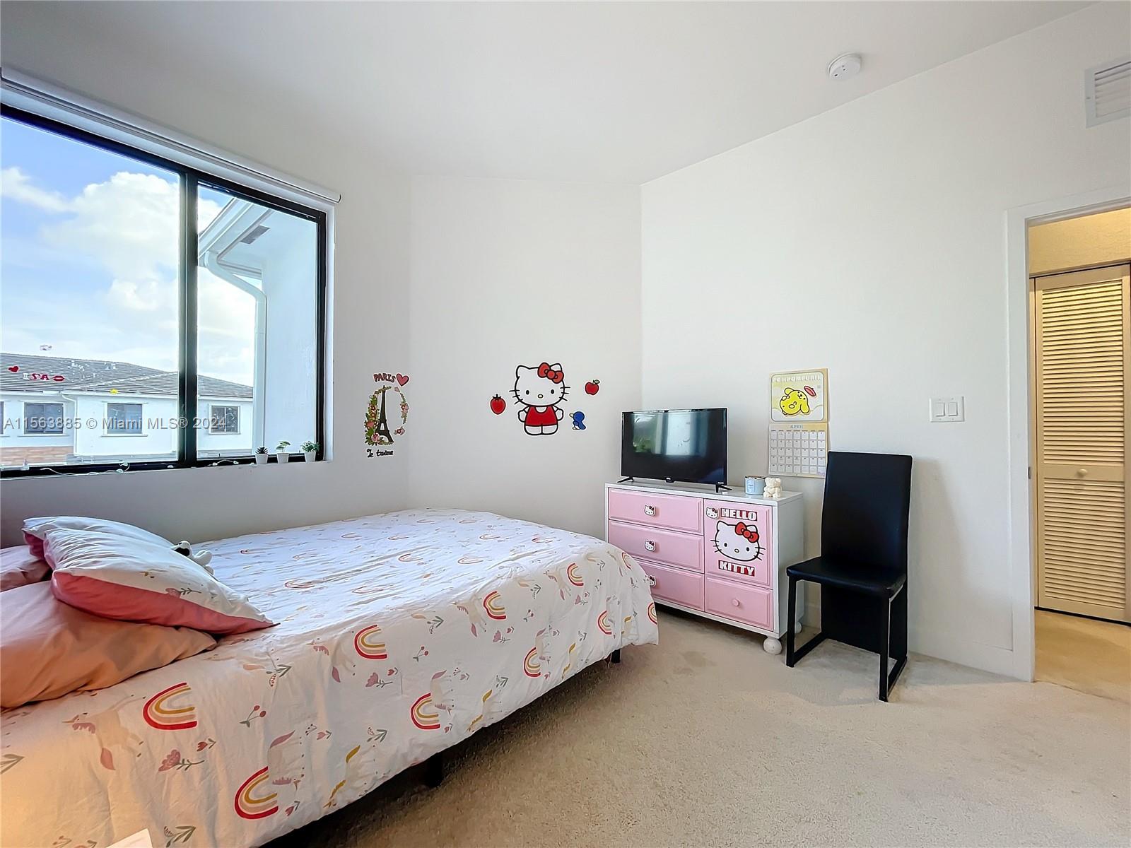 10888 Southwest 235th Lane Homestead, FL 33032 - Photo 22 of 36 a bedroom with a bed and a window