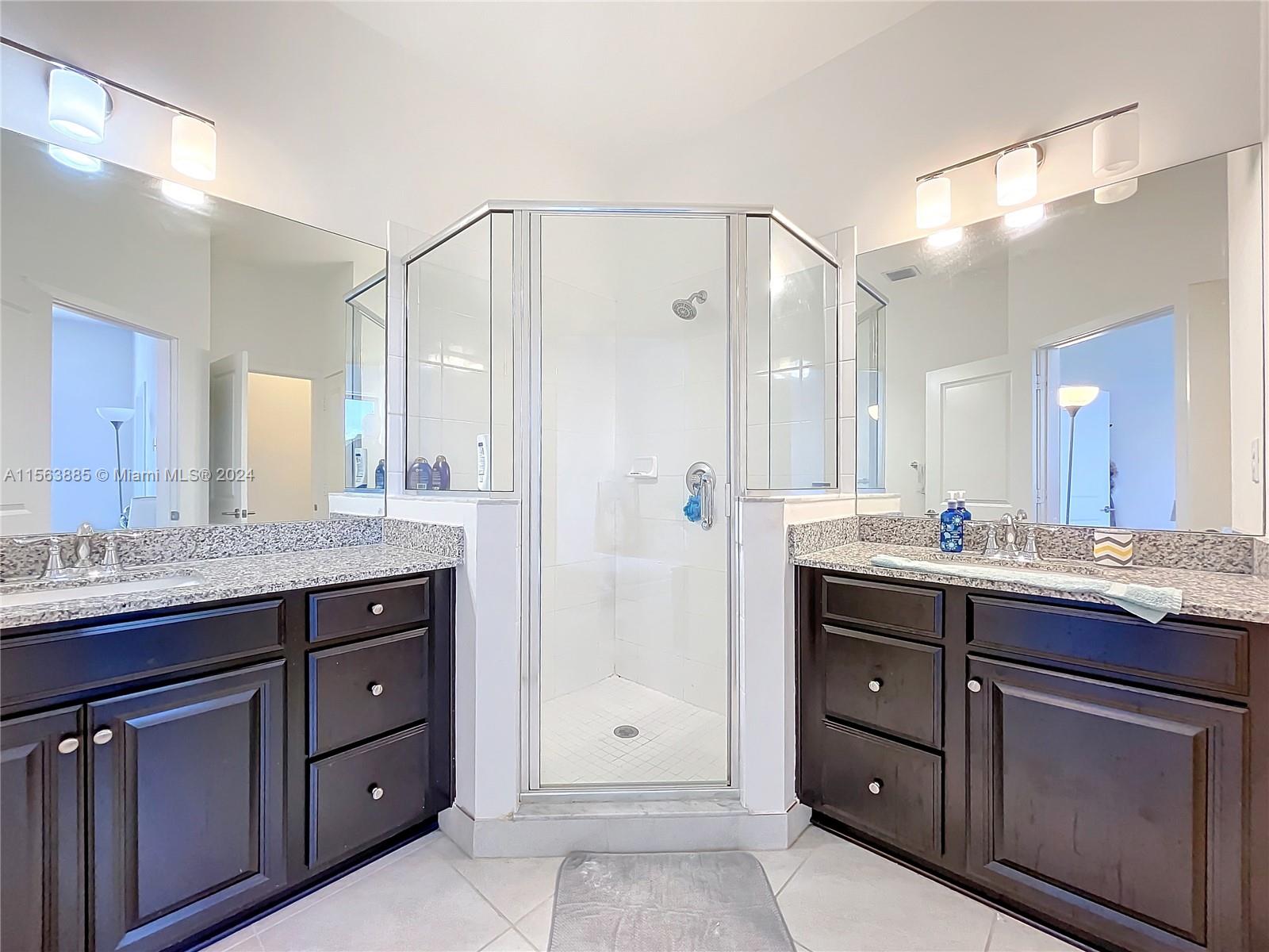 10888 Southwest 235th Lane Homestead, FL 33032 - Photo 25 of 36 a bathroom with a granite countertop sink mirror and double