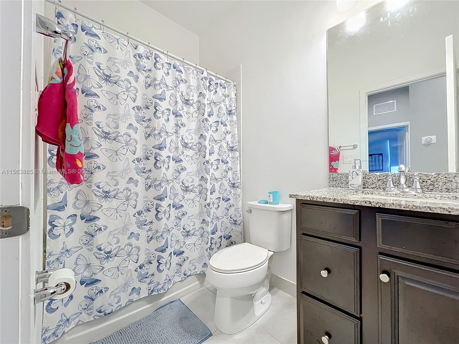10888 Southwest 235th Lane Homestead, FL 33032 - Photo 26 of 36 a bathroom with a sink toilet and shower