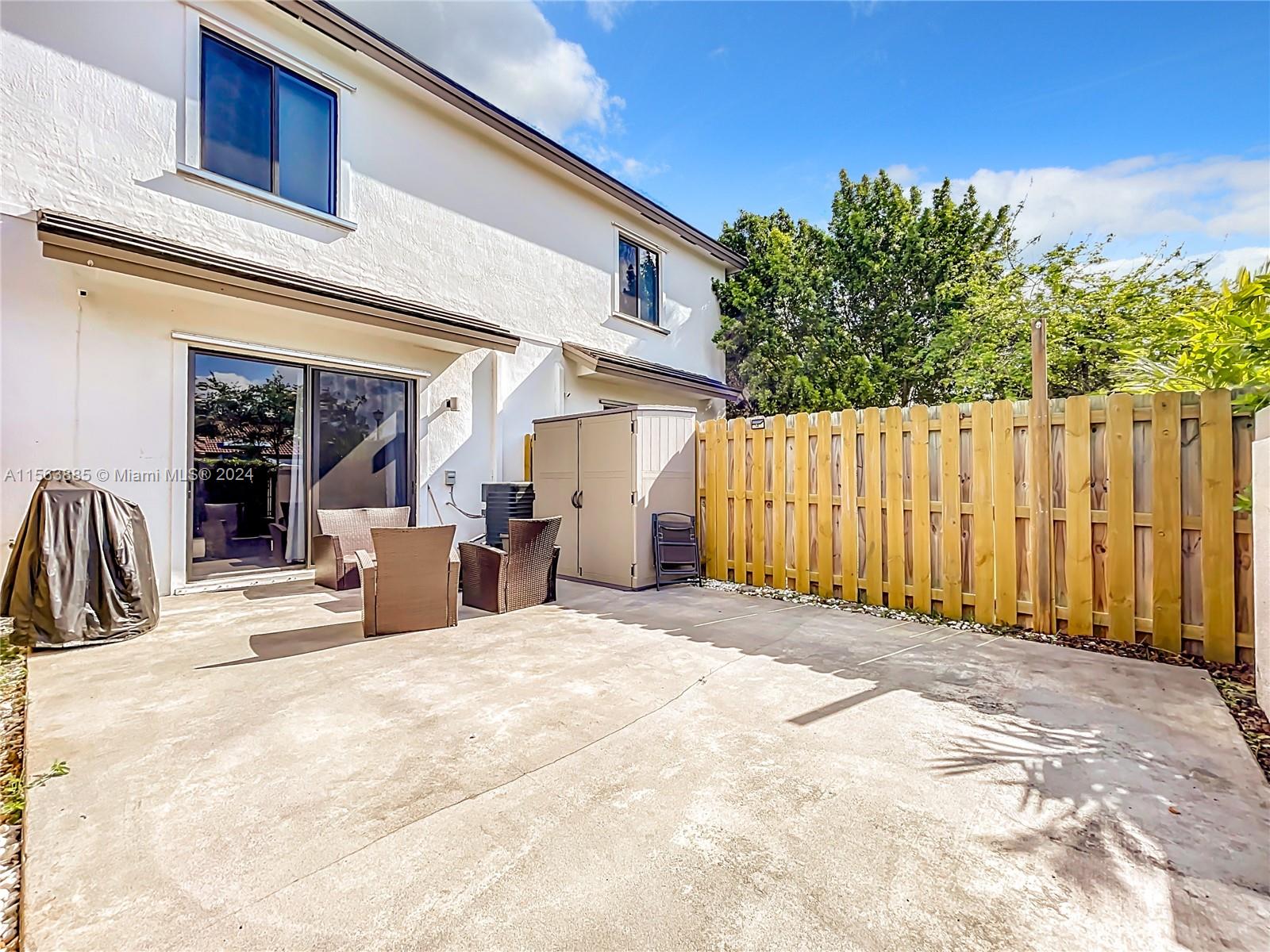 10888 Southwest 235th Lane Homestead, FL 33032 - Photo 29 of 36 a view of a house with wooden fence