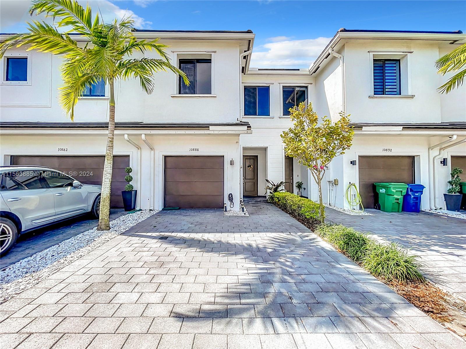 10888 Southwest 235th Lane Homestead, FL 33032 - Photo 3 of 36 a view of a house with a yard and garage