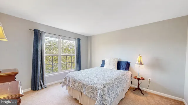 a bathroom with a granite countertop sink a mirror and shower