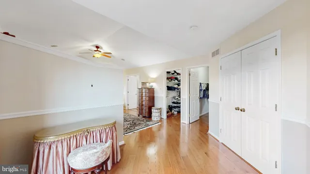 a bedroom with bed and walk in closet