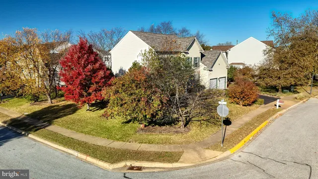 an aerial view of ocean and residential houses with outdoor space