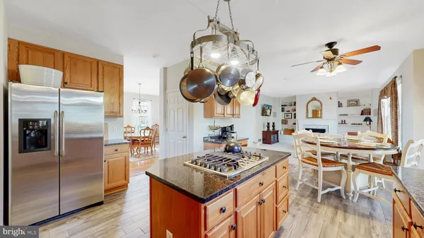 a kitchen with stainless steel appliances granite countertop a stove a sink dishwasher and cabinets with wooden floor