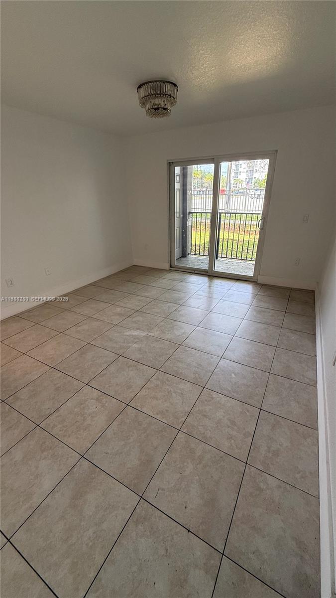 15480 Southwest 284th Street, Unit 2111 Homestead, FL 33033 - Photo 3 of 16 a view of an empty room with a window