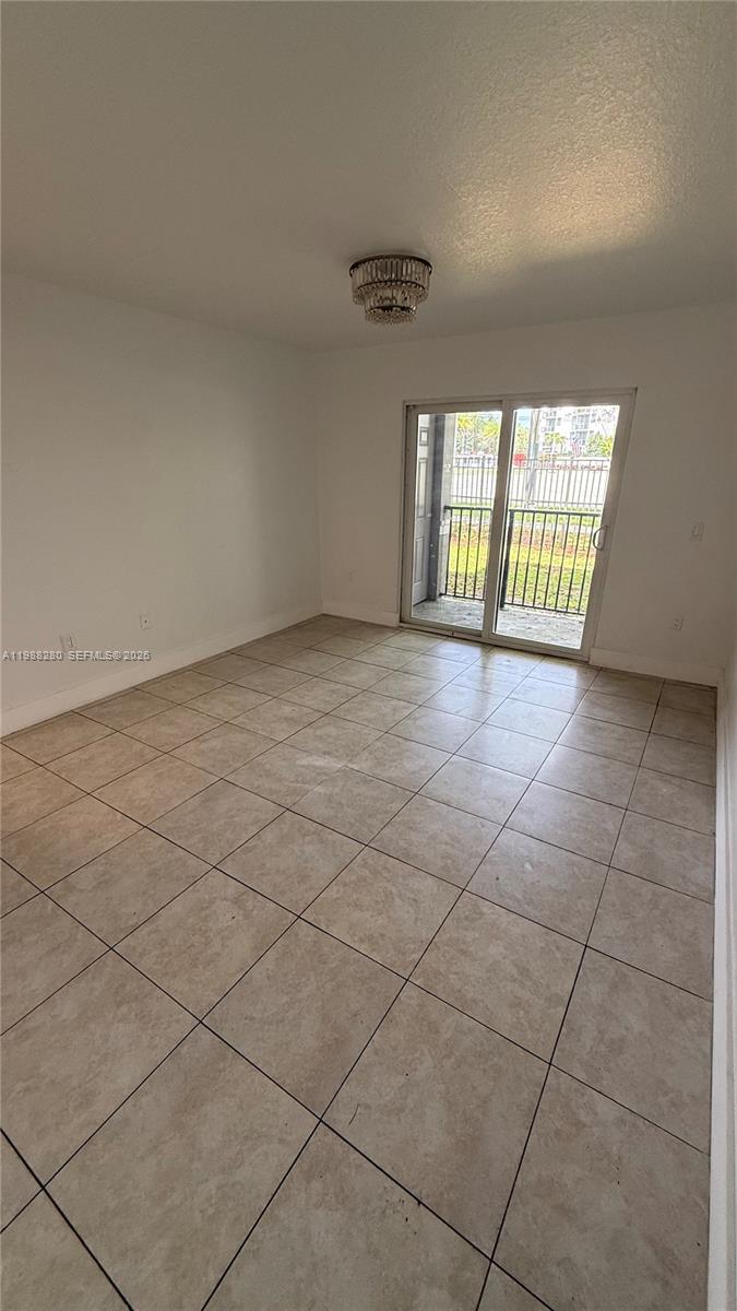 15480 Southwest 284th Street, Unit 2111 Homestead, FL 33033 - Photo 4 of 16 a view of an empty room with a window