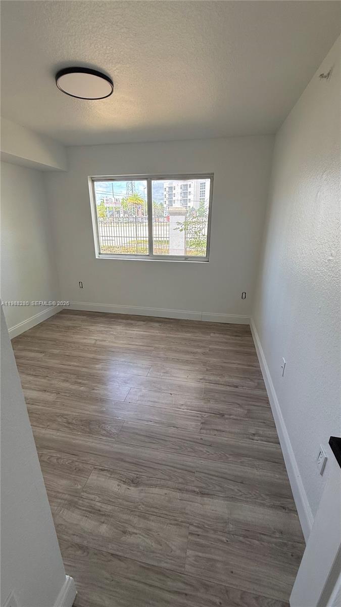 15480 Southwest 284th Street, Unit 2111 Homestead, FL 33033 - Photo 9 of 16 wooden floor in an empty room with a window
