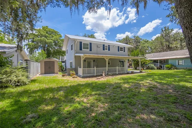 a view of an house with backyard space and balcony