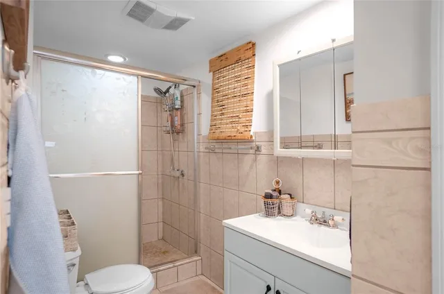 a bath room with a white couch and a potted plant