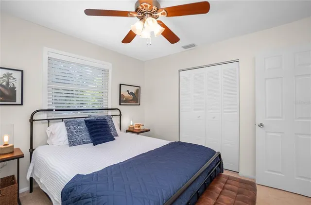 a backyard of a house with plants and large tree