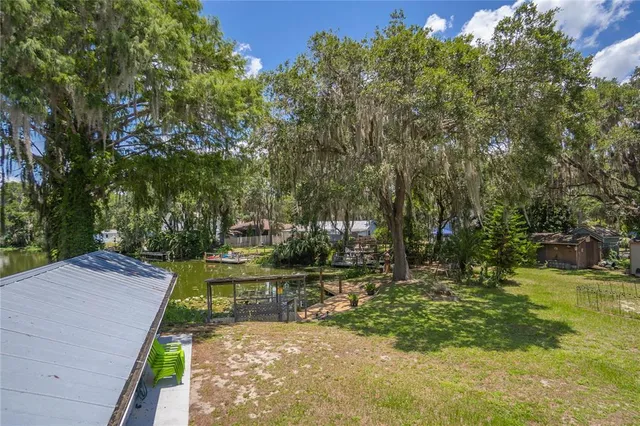 an aerial view of a houses with outdoor space and lake view