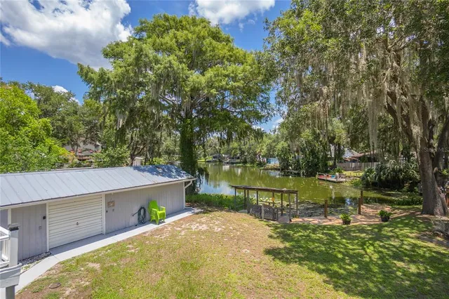 an aerial view of residential houses with outdoor space and river