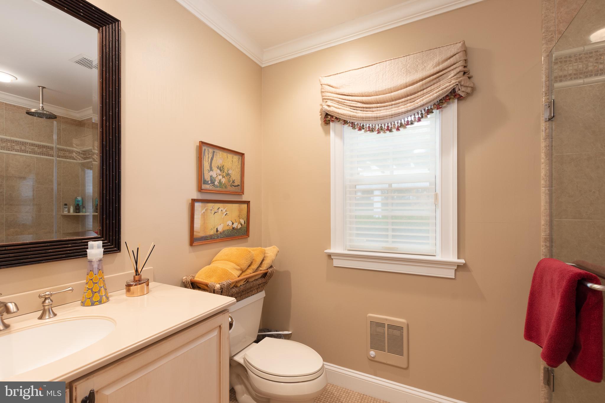 301 High Ridge Road Wilmington, DE 19807 - Photo 29 of 70 a bathroom with a sink a toilet and a mirror