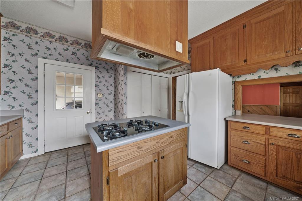 153 Miller Drive Tryon, NC 28782 - Photo 12 of 28 a kitchen with stainless steel appliances a stove a refrigerator and cabinets