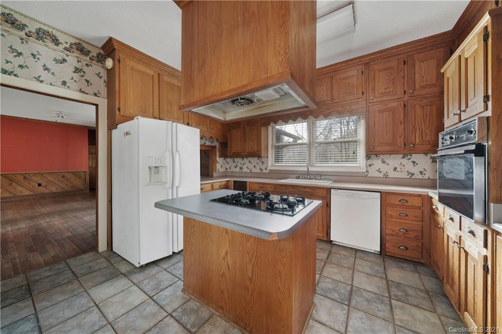 153 Miller Drive Tryon, NC 28782 - Photo 13 of 28 a kitchen with stainless steel appliances granite countertop a stove a refrigerator and a sink