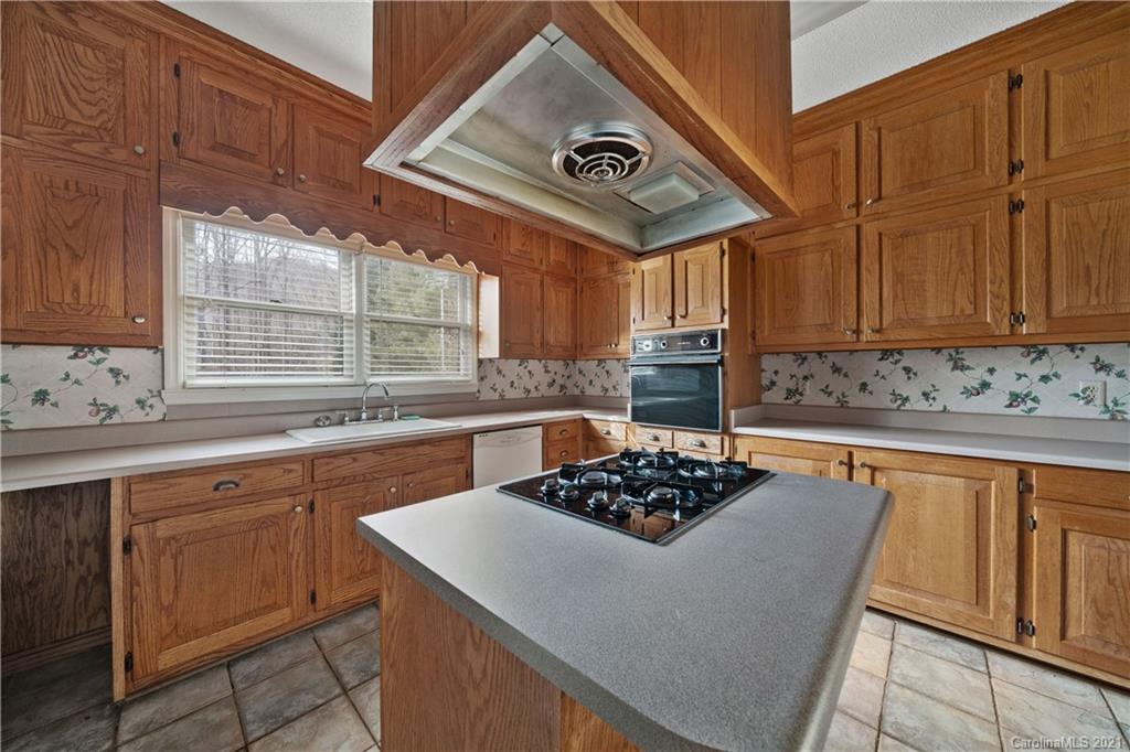 153 Miller Drive Tryon, NC 28782 - Photo 14 of 28 a kitchen with a stove a sink and cabinets
