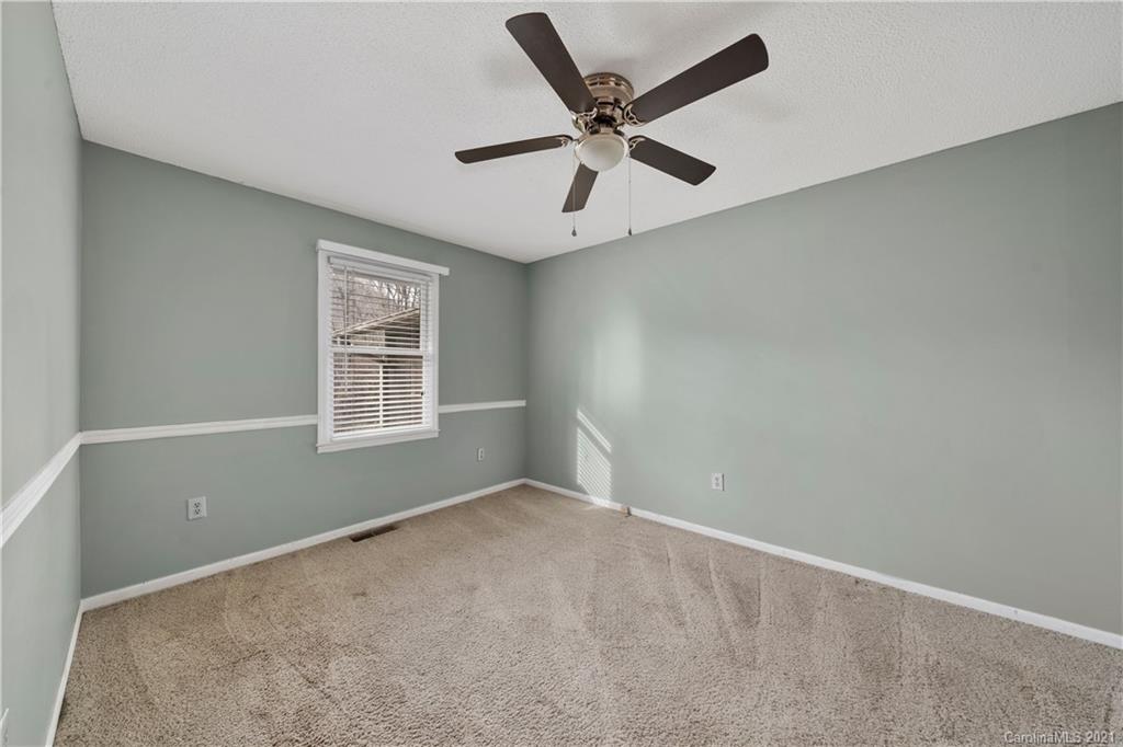 153 Miller Drive Tryon, NC 28782 - Photo 20 of 28 an empty room with ceiling fan and windows