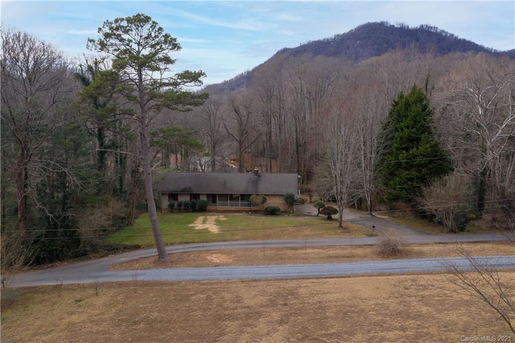 153 Miller Drive Tryon, NC 28782 - Photo 3 of 28 a view of a house with a yard and large tree