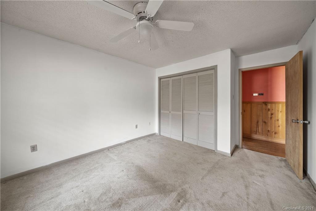 153 Miller Drive Tryon, NC 28782 - Photo 21 of 28 an empty room with closet and fan