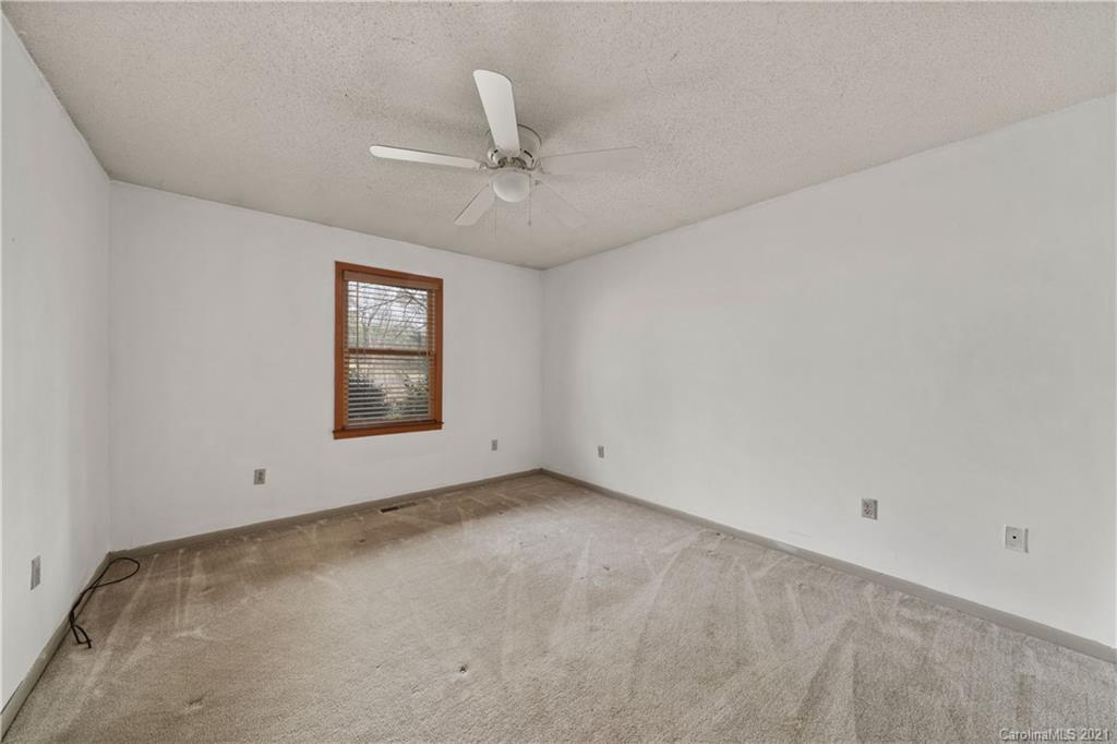 153 Miller Drive Tryon, NC 28782 - Photo 22 of 28 an empty room with a window and ceiling fan
