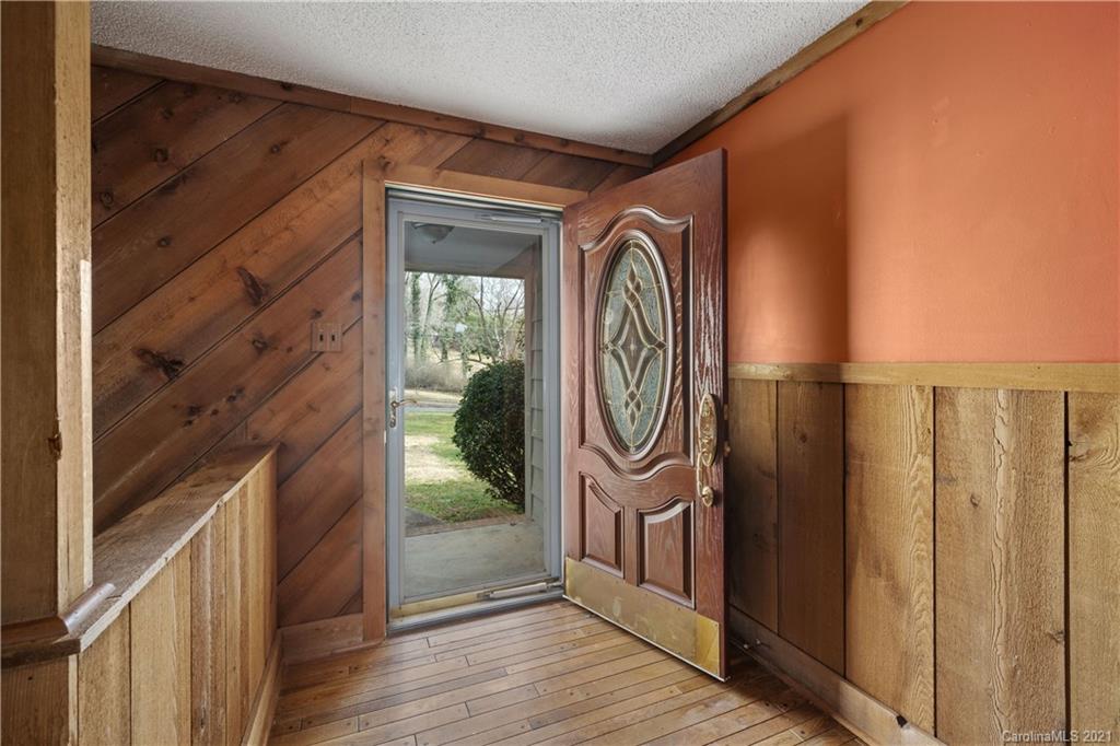 153 Miller Drive Tryon, NC 28782 - Photo 6 of 28 a front view of a house with a door and wooden floor