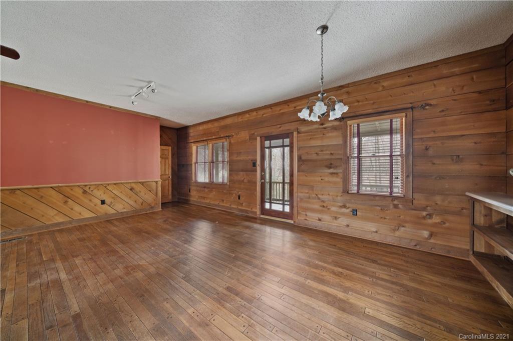153 Miller Drive Tryon, NC 28782 - Photo 8 of 28 a view of an empty room with wooden floor and a window