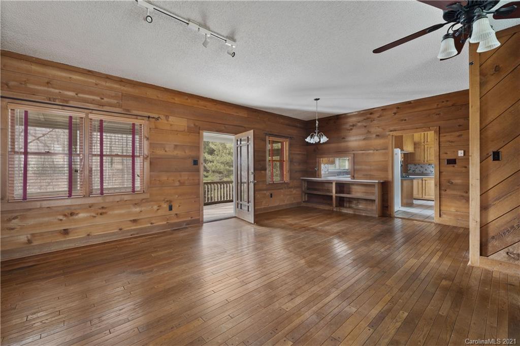 153 Miller Drive Tryon, NC 28782 - Photo 9 of 28 a view of an empty room with a window and wooden floor