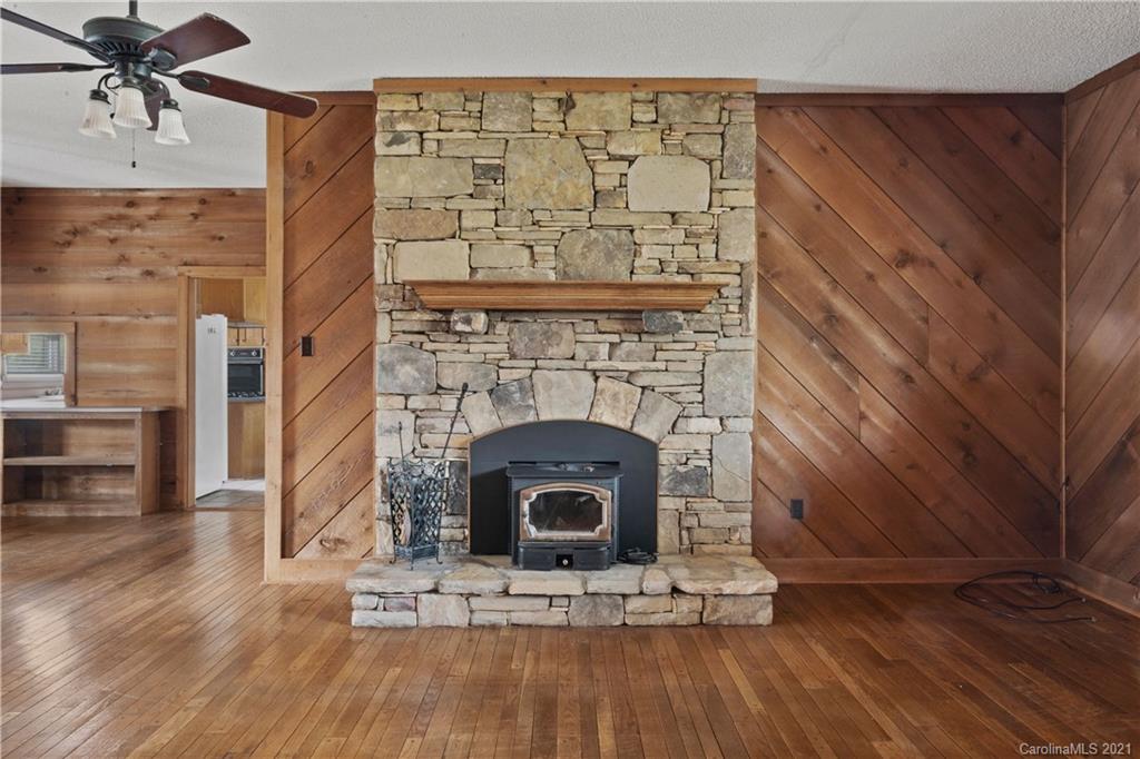 153 Miller Drive Tryon, NC 28782 - Photo 10 of 28 a living room with a fireplace and a wooden floor