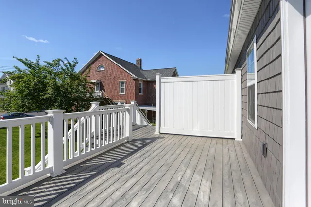 a view of a house with wooden deck