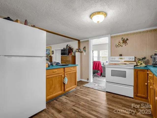 a kitchen with white cabinets and white appliances