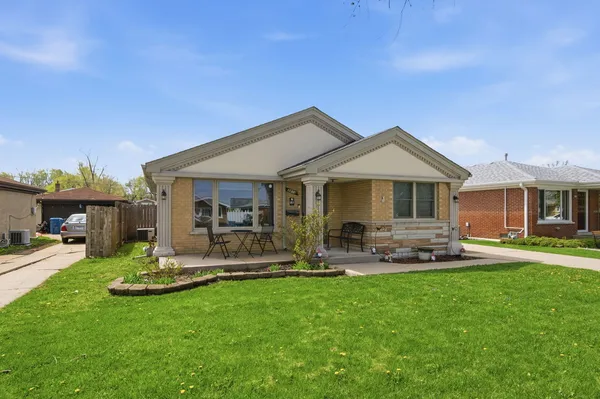 a front view of a house with a garden and patio
