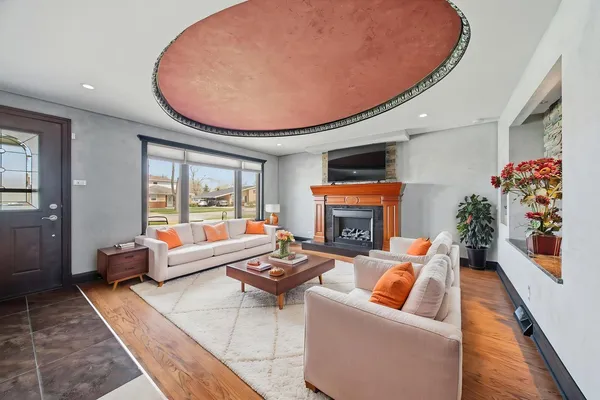 a living room with furniture and a fireplace