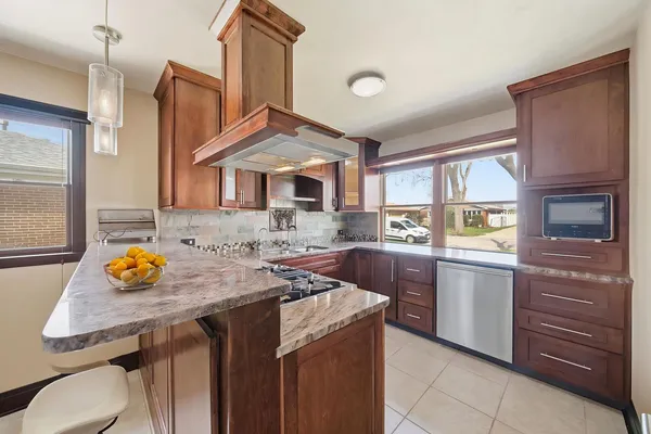 a kitchen that has a sink and a stove