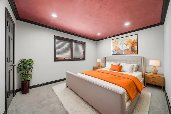 a bedroom with a bed and a potted plant
