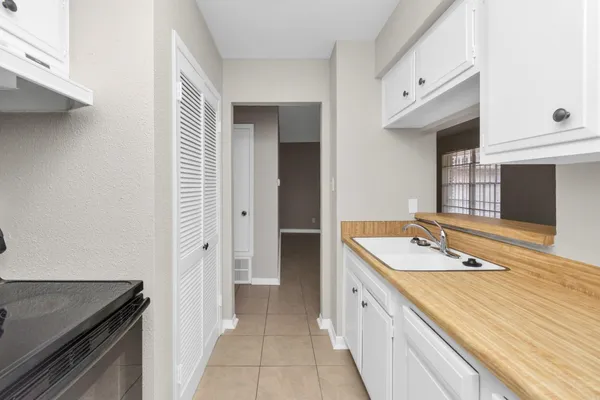 a room view with a wooden floor and cabinets