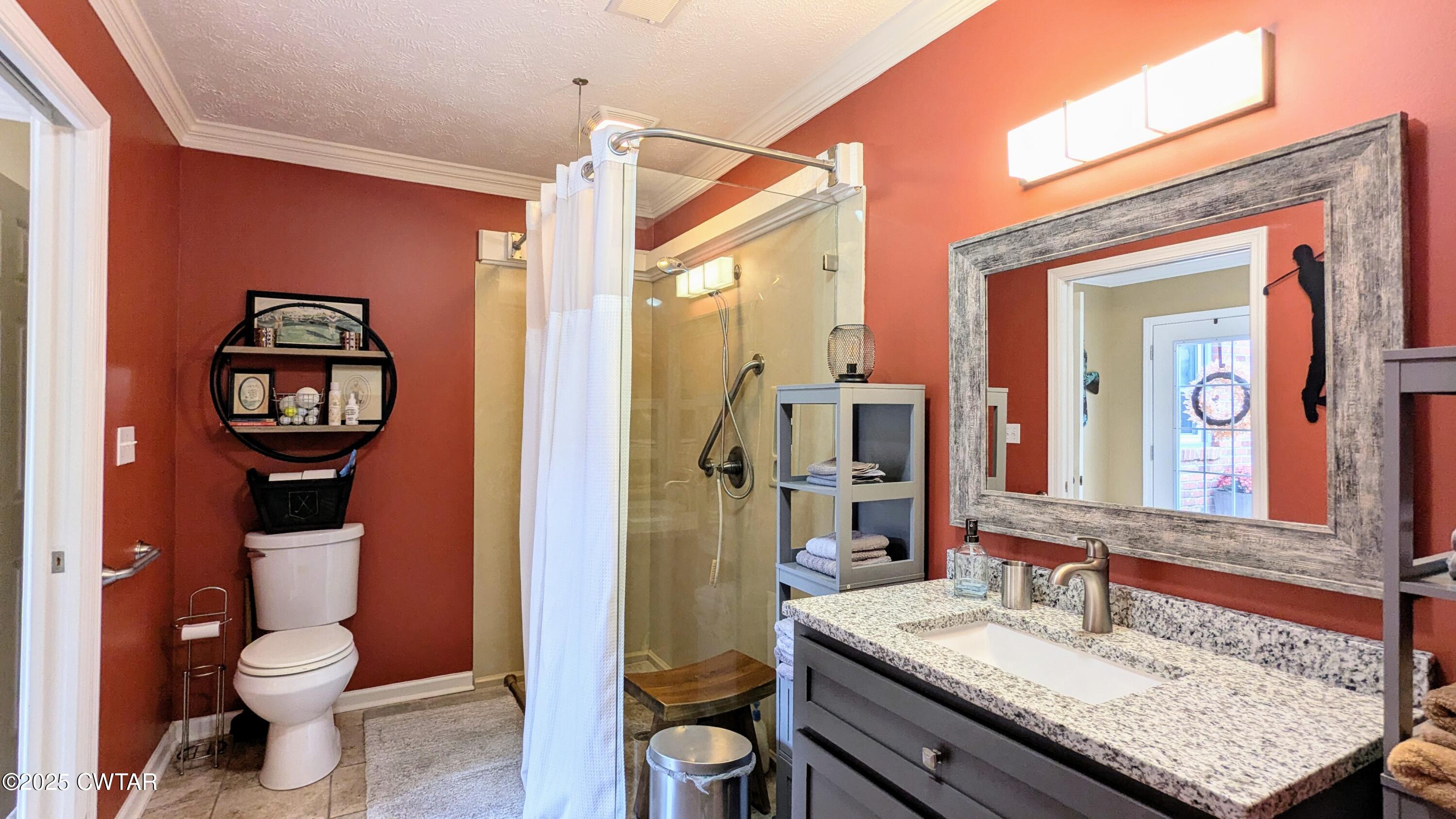 614 Oneal Lane Henderson, TN 38340 - Photo 36 of 69 a bathroom with a granite countertop sink toilet and shower