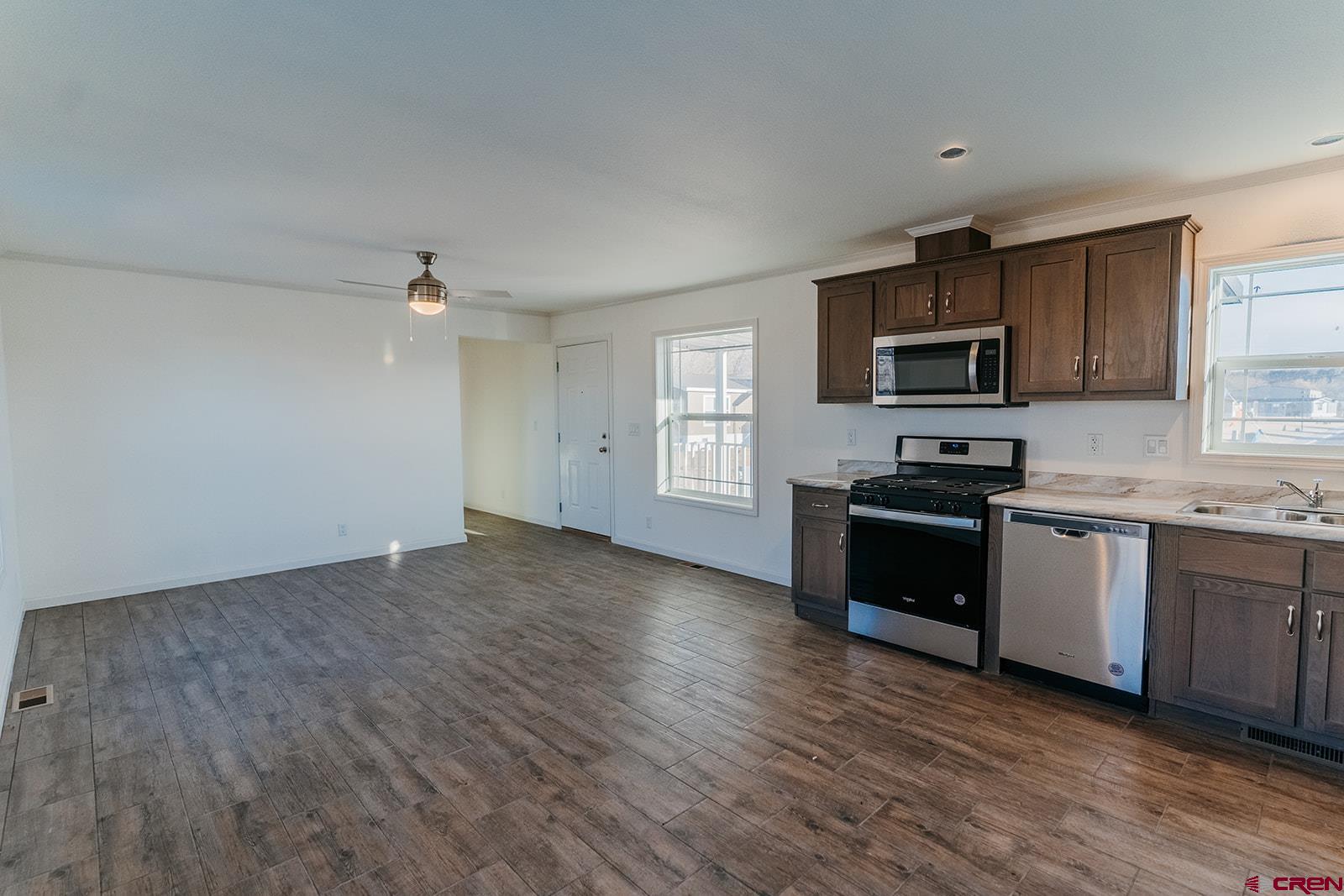 62650 Lasalle Road, Unit 341 Montrose, CO 81403 - Photo 11 of 22 a kitchen with sink a microwave and cabinets
