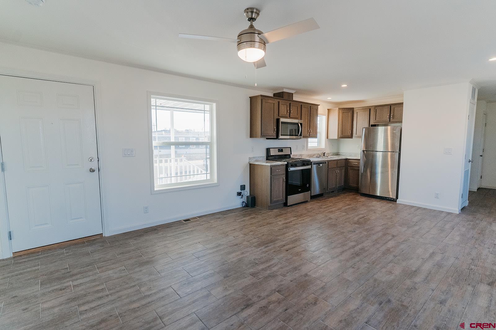 62650 Lasalle Road, Unit 341 Montrose, CO 81403 - Photo 12 of 22 a view of a kitchen with a stove cabinets and wooden floor